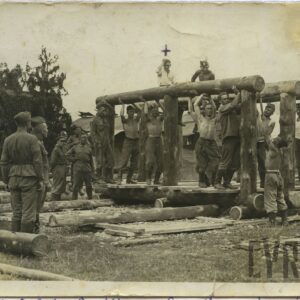 grupa mężczyzn podtrzymujących i stojących obok drewnianych beli