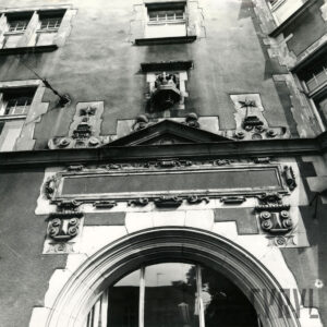 fragment łukowato zakończonego okna z bogatą płaskorzeźbą zwieńczoną koroną