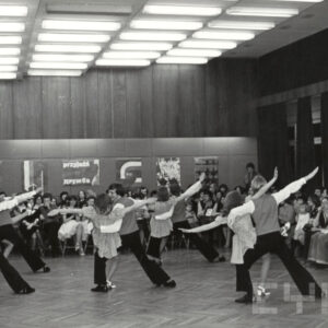 tańczące na parkiecie pary, dookoła nich siedzi publiczność