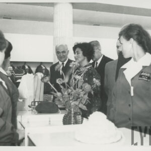 niewielka grupa kobiet i mężczyzn przy ladzie