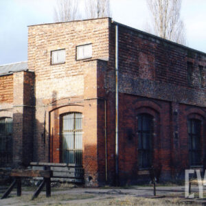 ceglany, niski budynek warsztatowy z dużymi oknami