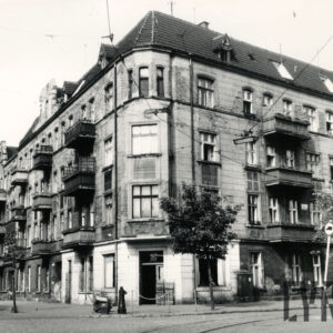 czterokondygnacyjna, narożna kamienica z balkonami i poddaszem