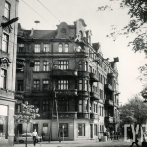 skrzyżowanie ulic, na narożniku kilkukondygnacyjna kamienica z balkonami