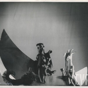 na dekoracji w kształcie księżyca siedzi postać Koziołka Matołka i lalka przedstawiająca mężczyznę z długi wąsami ubrana w pelerynę, obok kukiełka przedstawiająca psa