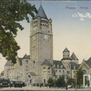 potężny zamek z dominującą, wysoką wieżą zegarową zakończoną hełmem