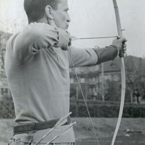 mężczyzna w stroju sportowym mierzący do celu z łuku