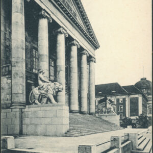 wejście do budynku z jednym rzędem sześciu kolumn, które wspierają trójkątny dach, na nim rzeźba konia ze skrzydłami, do budynku prowadzą szerokie schody, po obu ich stronach rzeźby