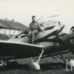 mężczyzna w stroju pilota siedzący na samolocie