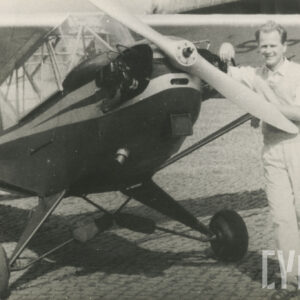 mężczyzna w średnim wieku pozujący do fotografii przy samolocie