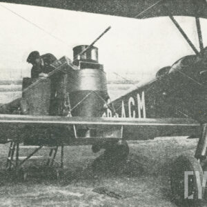 dwóch mężczyzn pracujących przy samolocie stojącym na trawiastym lądowisku