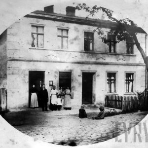 pięć osób pozujących do fotografii przed murowanym domem