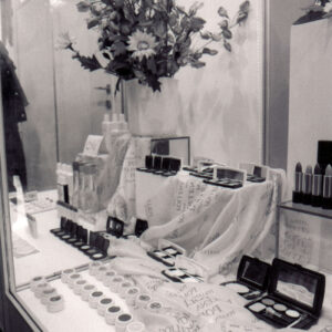 stoisko z kosmetykami ozdobione kwiatami w wazonach