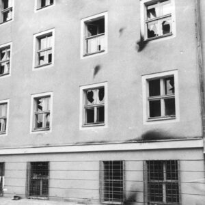 fragment elewacji pięciokondygnacyjnego budynku, ciemne po obrzuceniu budynku palącymi się butelkami z benzyną, powybijane szyby