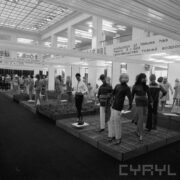 stoiska z ubranymi manekinami w hali wystawowej