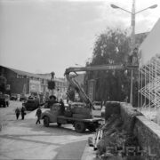 dwóch mężczyzn na podnośniku samochodowym montują elementy wystawy na terenie targów