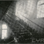 korytarz, schody i poręcze wewnątrz budynku; widoczne okna